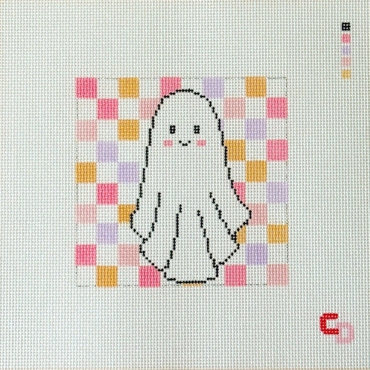 A completed needlepoint canvas featuring a cute white ghost with a black outline, pink cheeks, and a pastel pink, purple, and orange checkered background. The canvas is framed by a beige border printed with the brand name 'Catswold'.